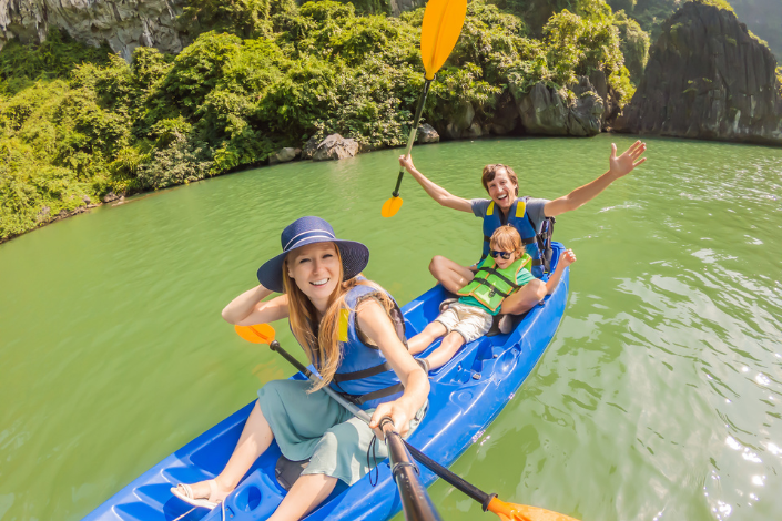 a family kayaking and posing for a pic together