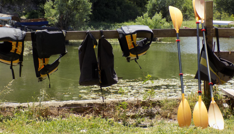 essential gear for a kayaking and camping trip that is out in the sun, drying