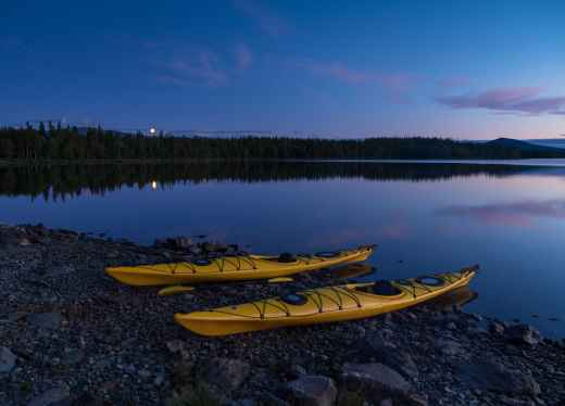 kayaks prepared with moon coming up