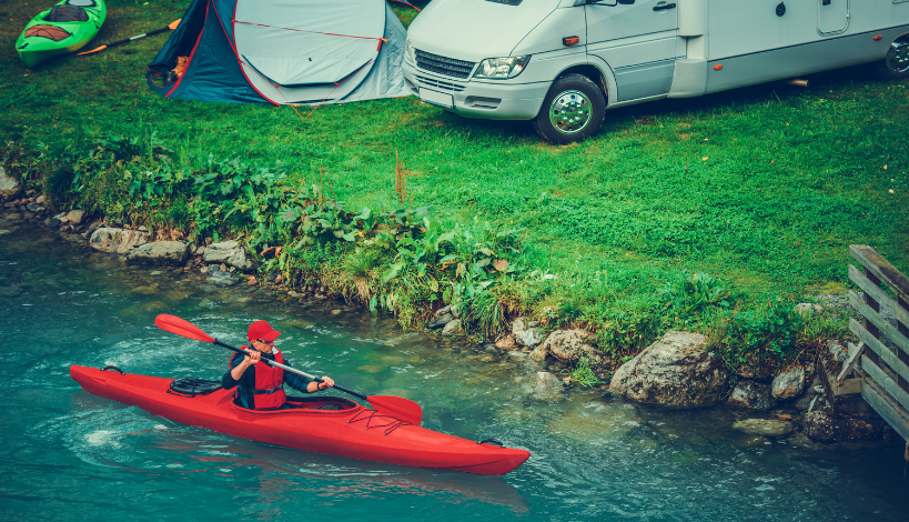 man equipping his kayak to go kayak camping