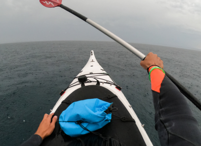 rain coming down unexpectedly while kayaking on the ocean