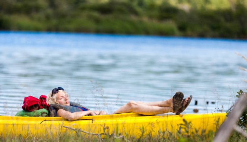 tired woman napping in her kayak